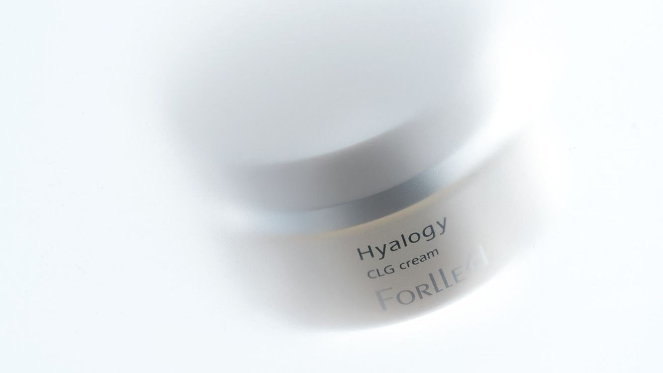 White jar of Hyalogy CLG cream on a white background
