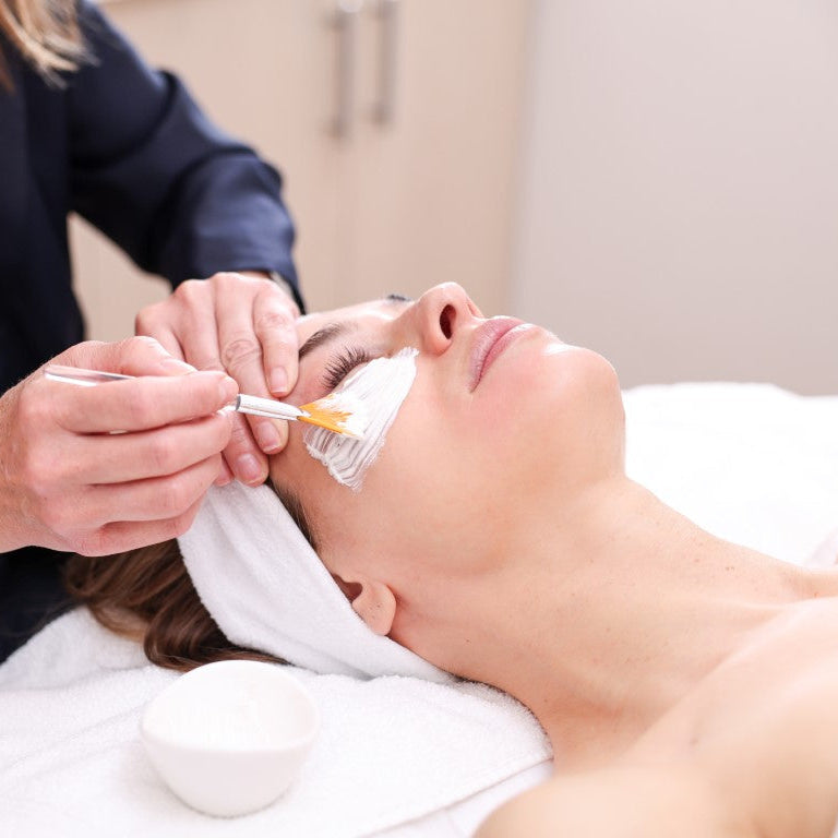 Person receiving a facial treatment with Aida Bicaj at Tribeca Spa.