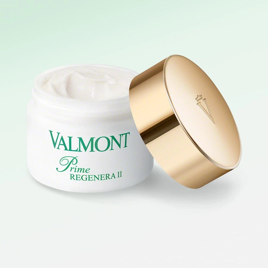 Valmont skincare product with gold lid on a light green background